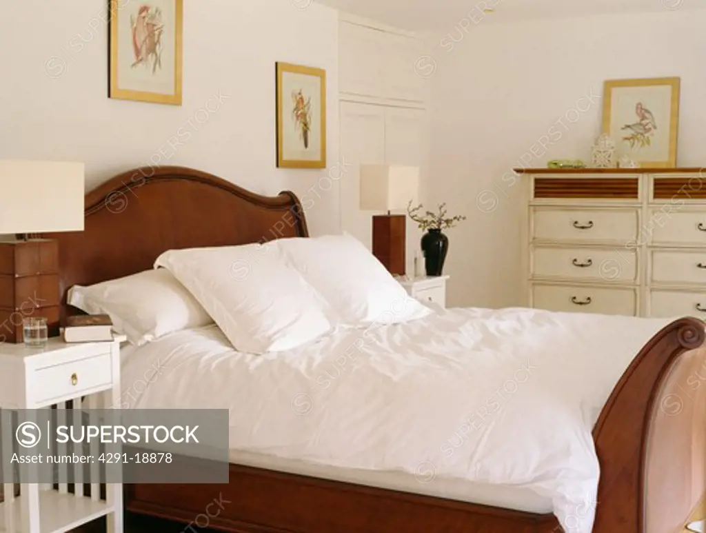 White linen on mahogany bed in cream country bedroom