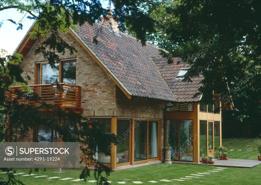 Modern country house with reclaimed roof pantiles and wooden balcony