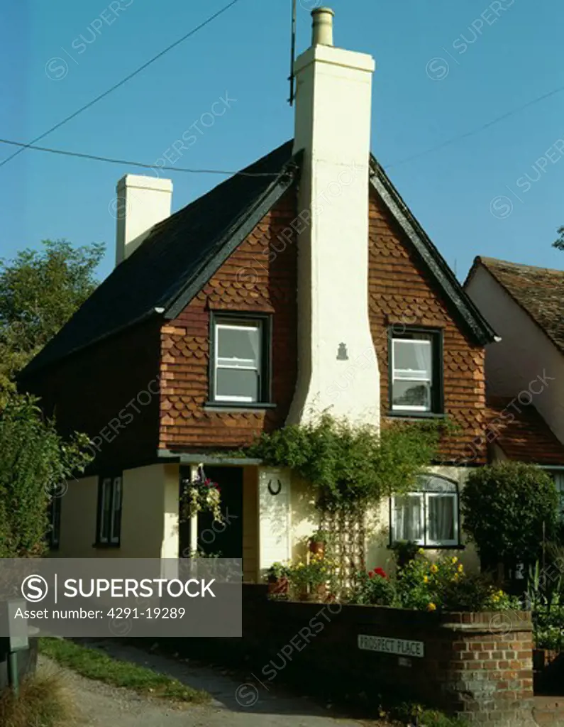 Cottage with tall white chimney and pantiles on the walls