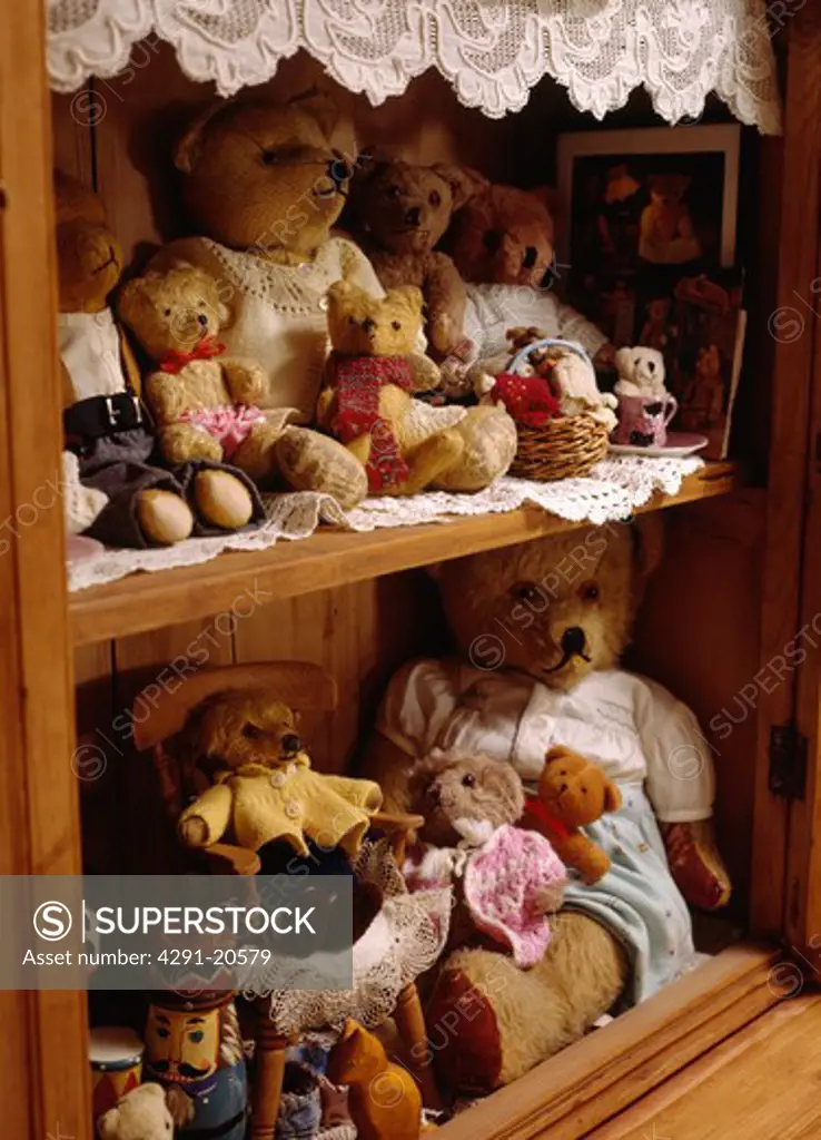 Close-up of collection of teddybears on old pine shelves