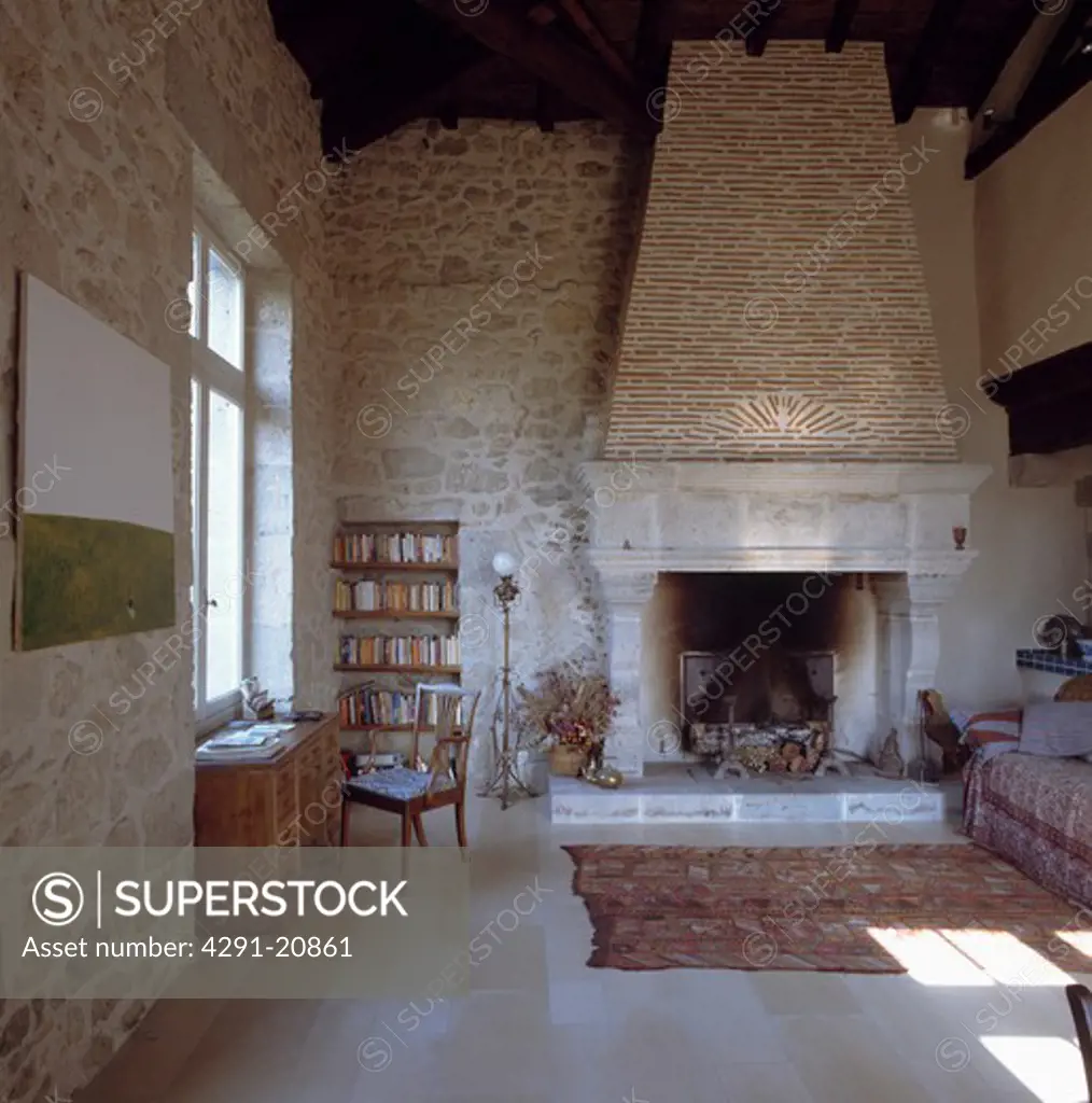 8th century French living room with stone walls and large fireplace