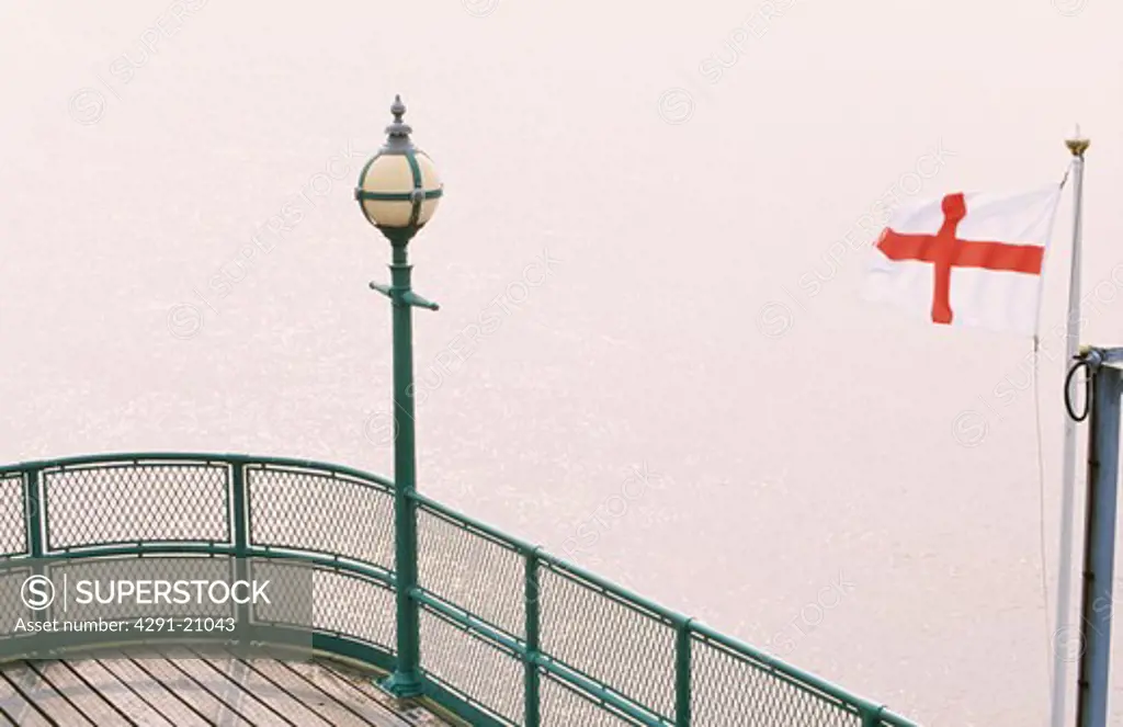 St George's flag and lamp standard on the pier in fog at Cleveland in Somerset