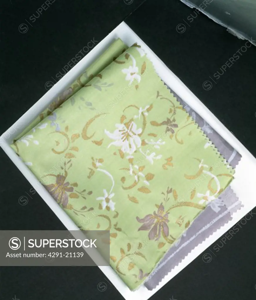 Close-up of patterned pale green fabric swatches