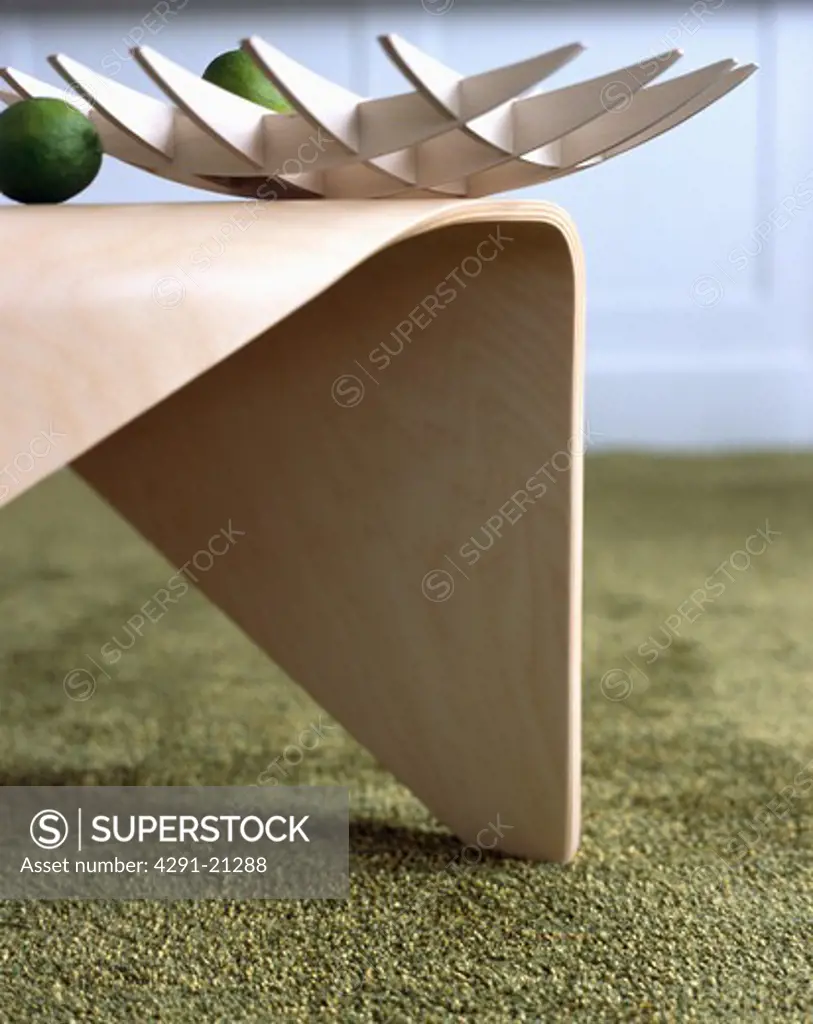 Close-up of modern bowl on moulded plywood table