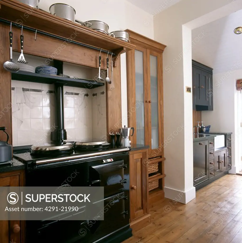 Black Aga in traditional town kitchen with polished wooden floor