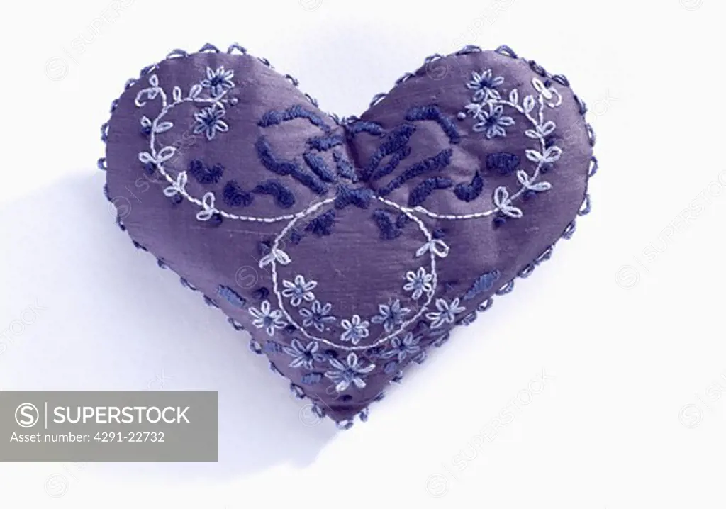 Close-up of embroidered blue silk heart
