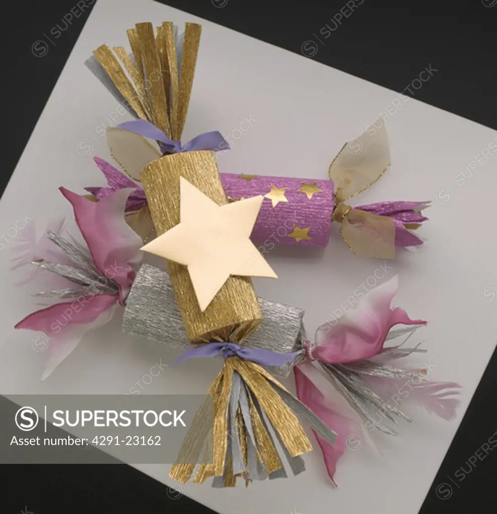Gold and purple Christmas crackers decorated with gold star