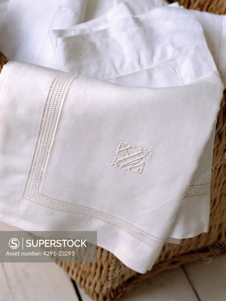 Close-up of monogrammed white linen pillowcases with drawn thread-work