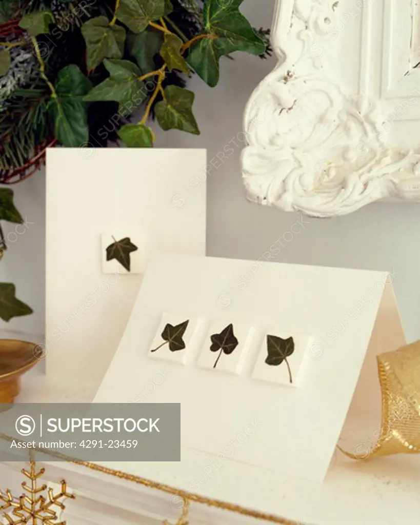 Close-up of ivy-leaves patterned white Christmas cards