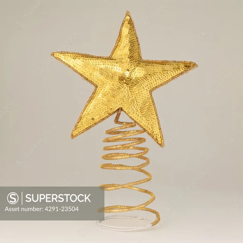 Gold sequin-covered star Christmas tree decoration on gold wire spring
