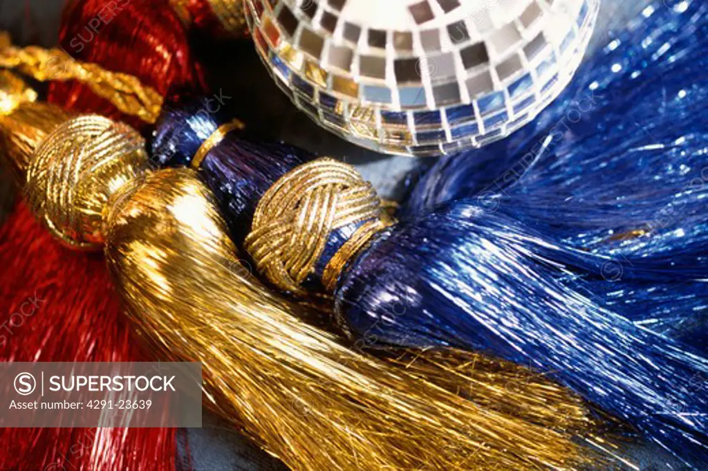 Close-up of gold and blue metallic tassels