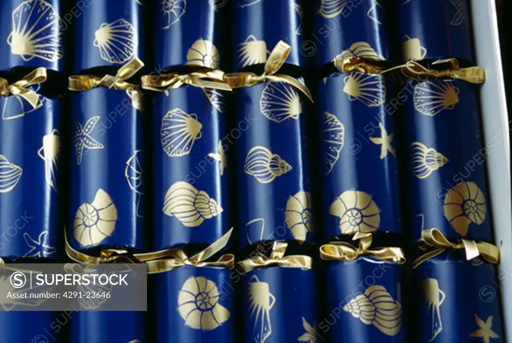 Close-up of box of home-made gold patterned blue Christmas crackers