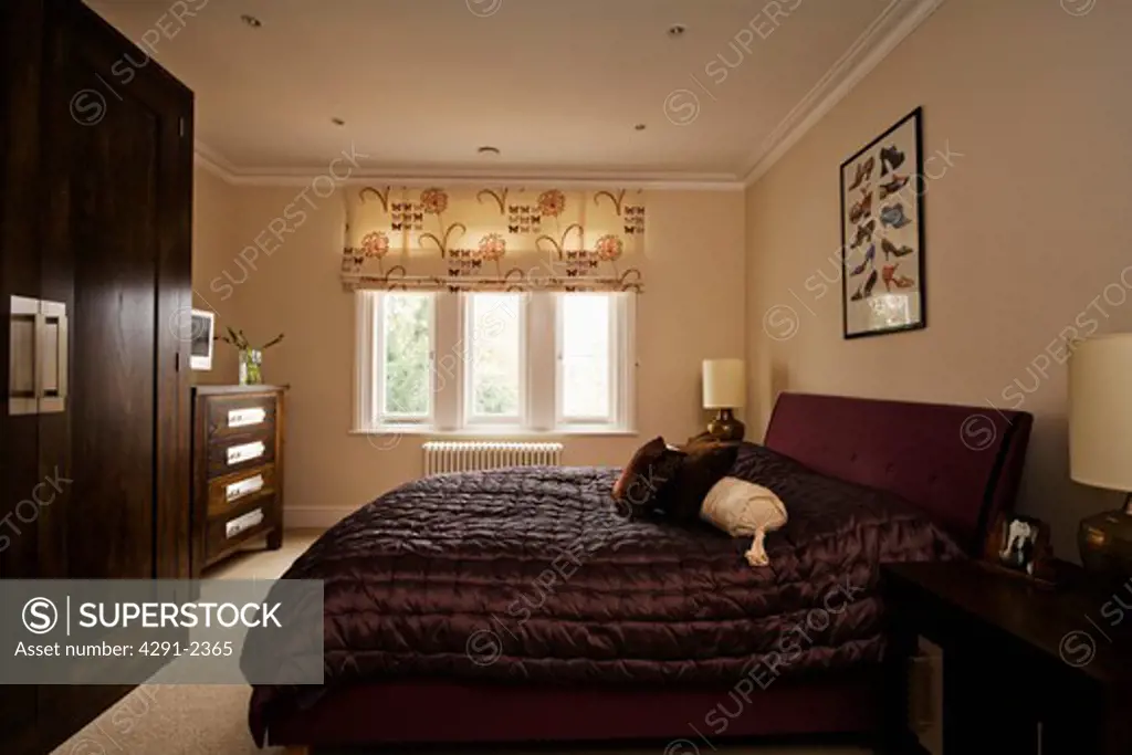 Black quilt and patterned blind in cream bedroom