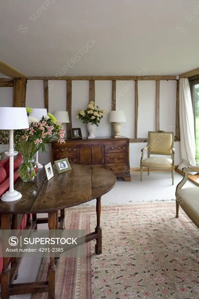 Antique oak table and silk rug in country living room