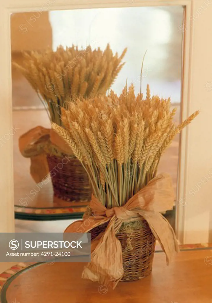 Close-up of cornsheaf in basket in front of mirror