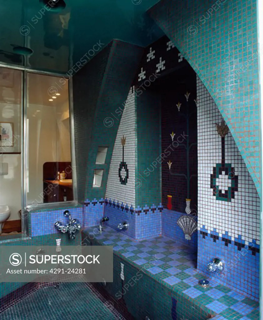 Turquoise blue and white patterned mosaic tiled wall above sunken bath in Moorish-style bathroom