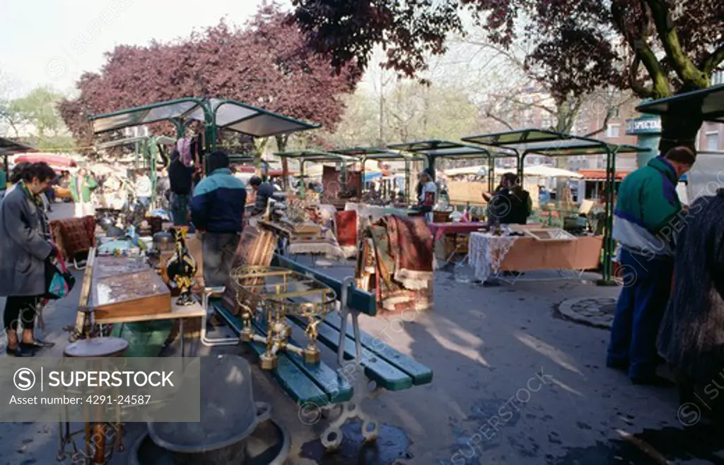 Stall-holders and people browsing in open-air market in Paris
