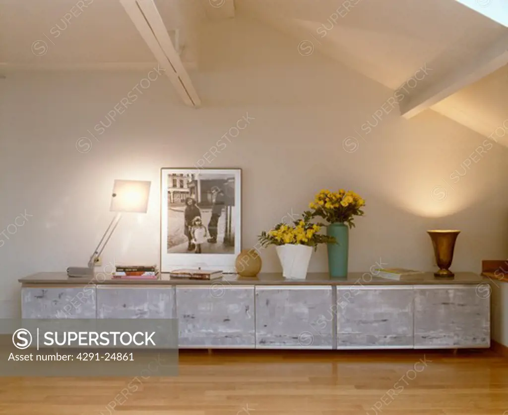 Low grey cupboards used for photographic storage in loft studio