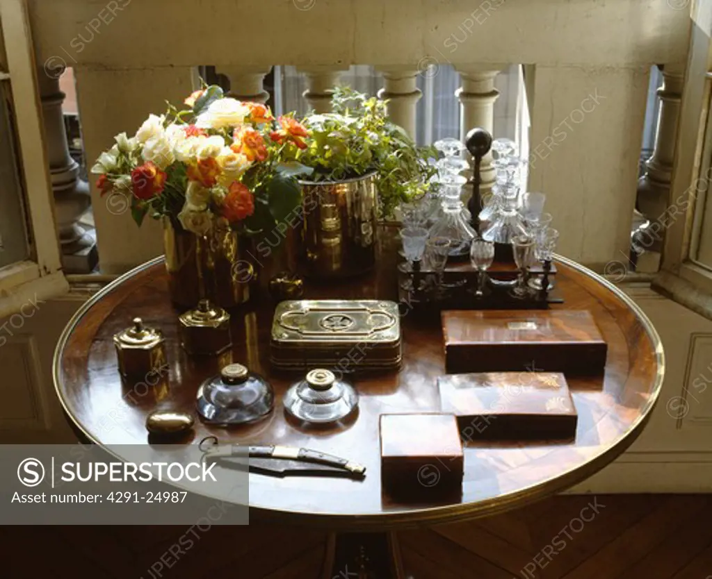 Close-up of collection of antique wood boxes and inkwells on antique table