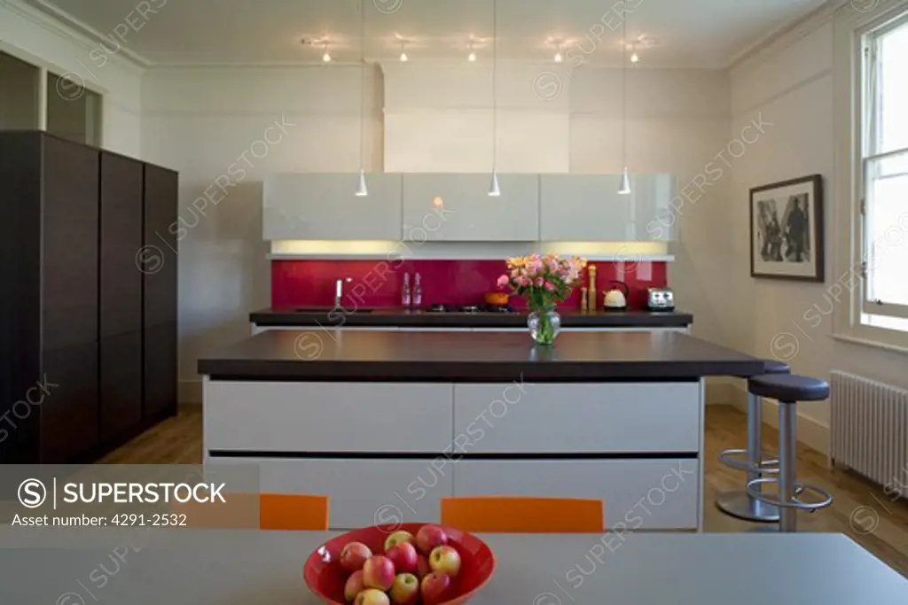 Downlighting in modern kitchen with island unit with cast concrete resin worktop