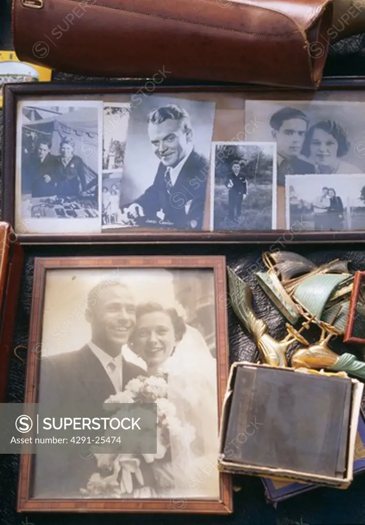Close-up of old black and white photographs displayed on market stall