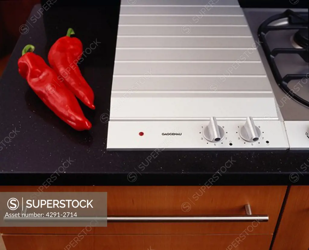 Close-up of red chilli peppers beside Gaggenau hob