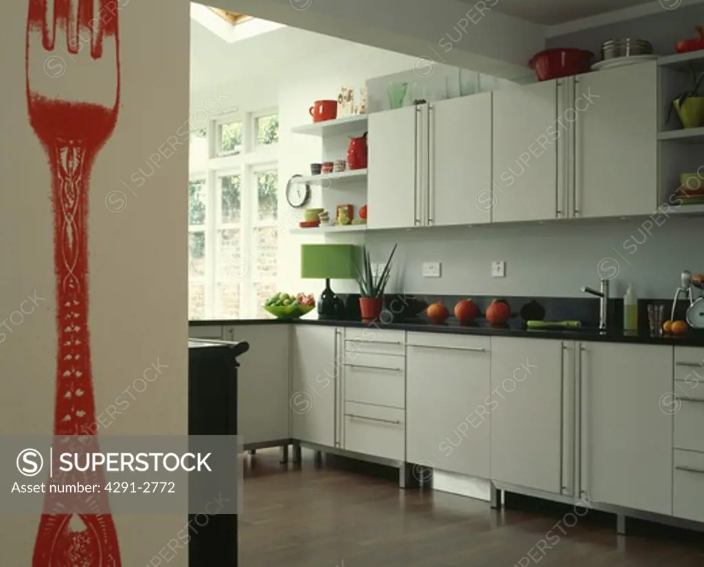 Large red fork painted on wall on modern kitchen extension