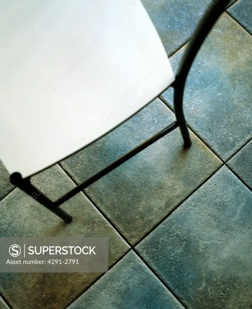 Close-up of modern chair on grey floor tiles