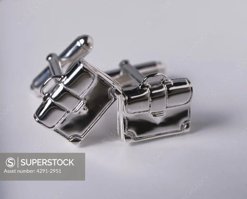 Close-up of briefcase-shaped silver cuff-links