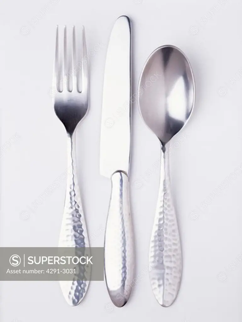Close-up of silver knife and fork with spoon