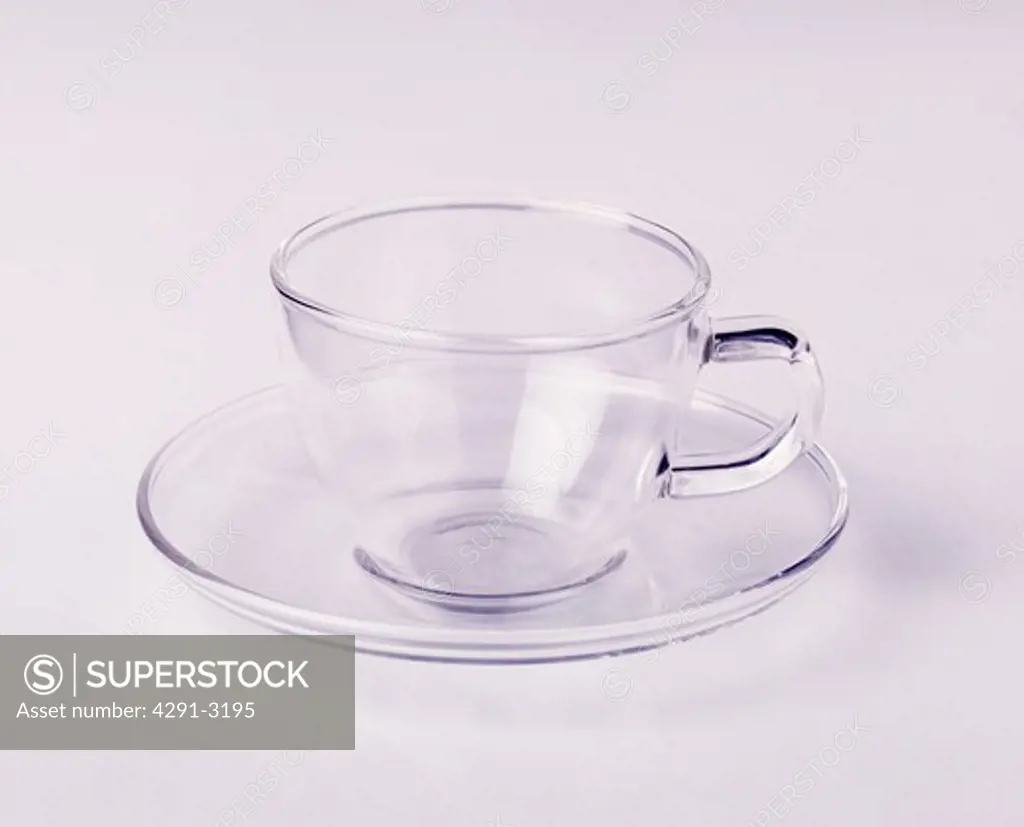 Close-up of glass cup and saucer