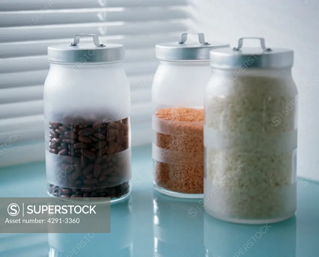 Close-up of hand-etched glass storage jars