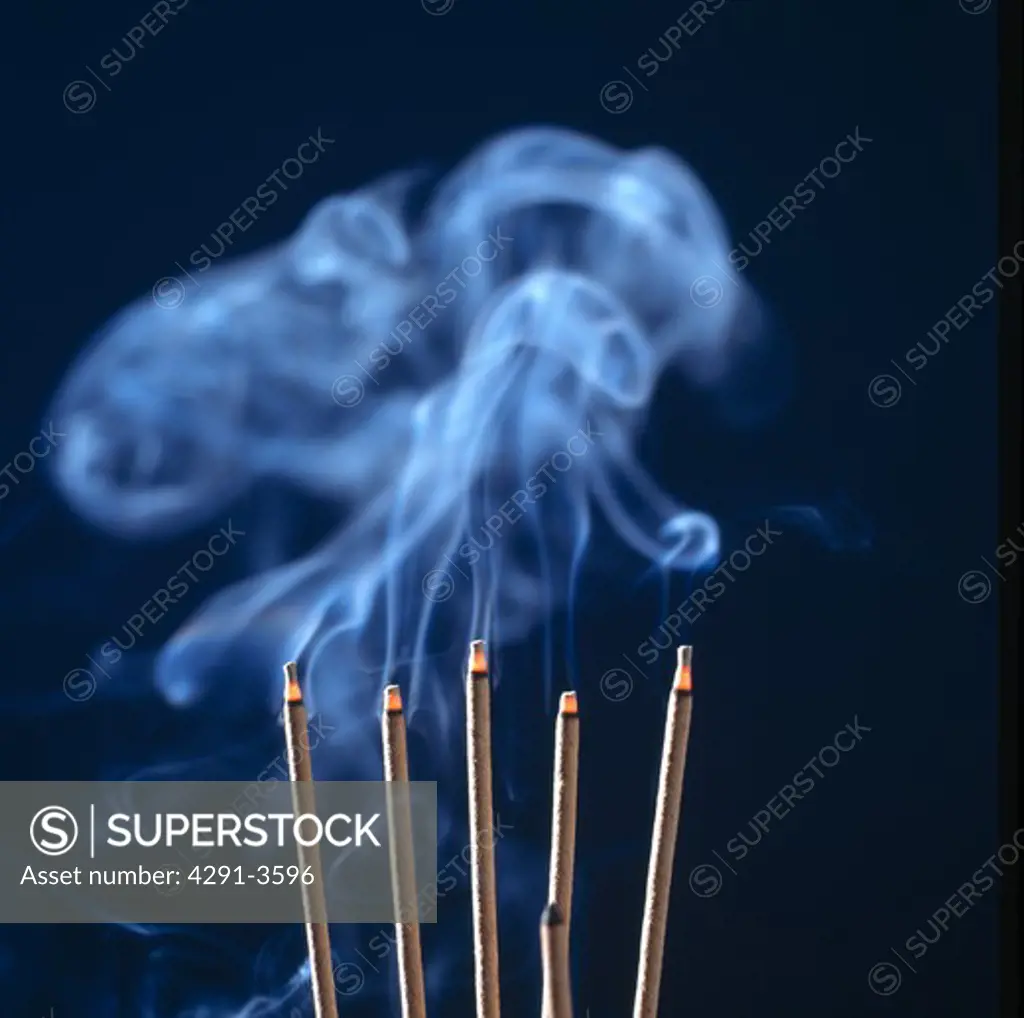 Close-up of smoke curling from joss-sticks