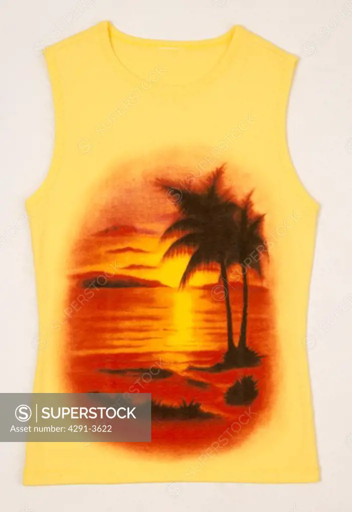 Close-up of yellow sleeveless t-shirt with sunset print on the front