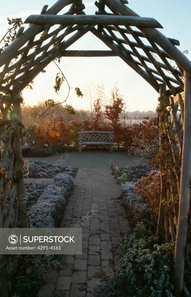 Wooden arch and pergola in country garden in winter