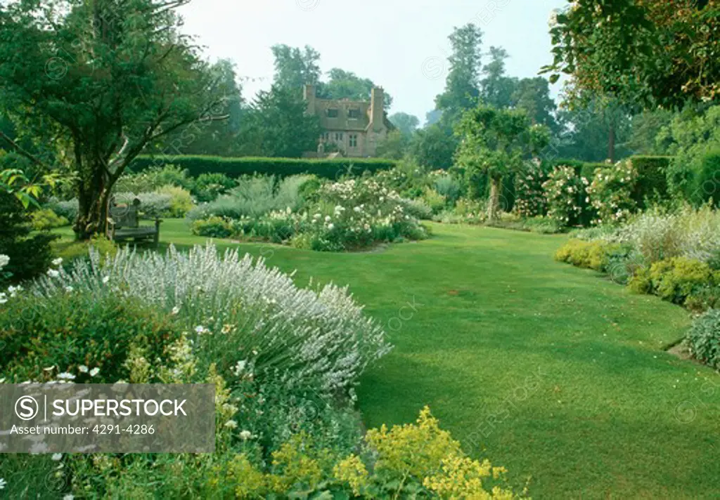Lawn and herbaceous border in large country garden in summer