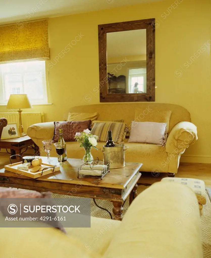 Cream sofas in yellow living room