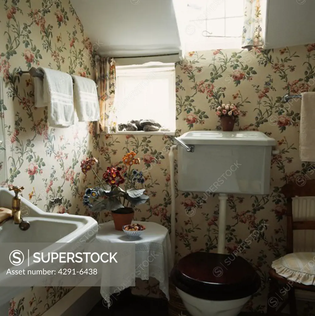 Floral patterned wallpaper in small attic bathroom
