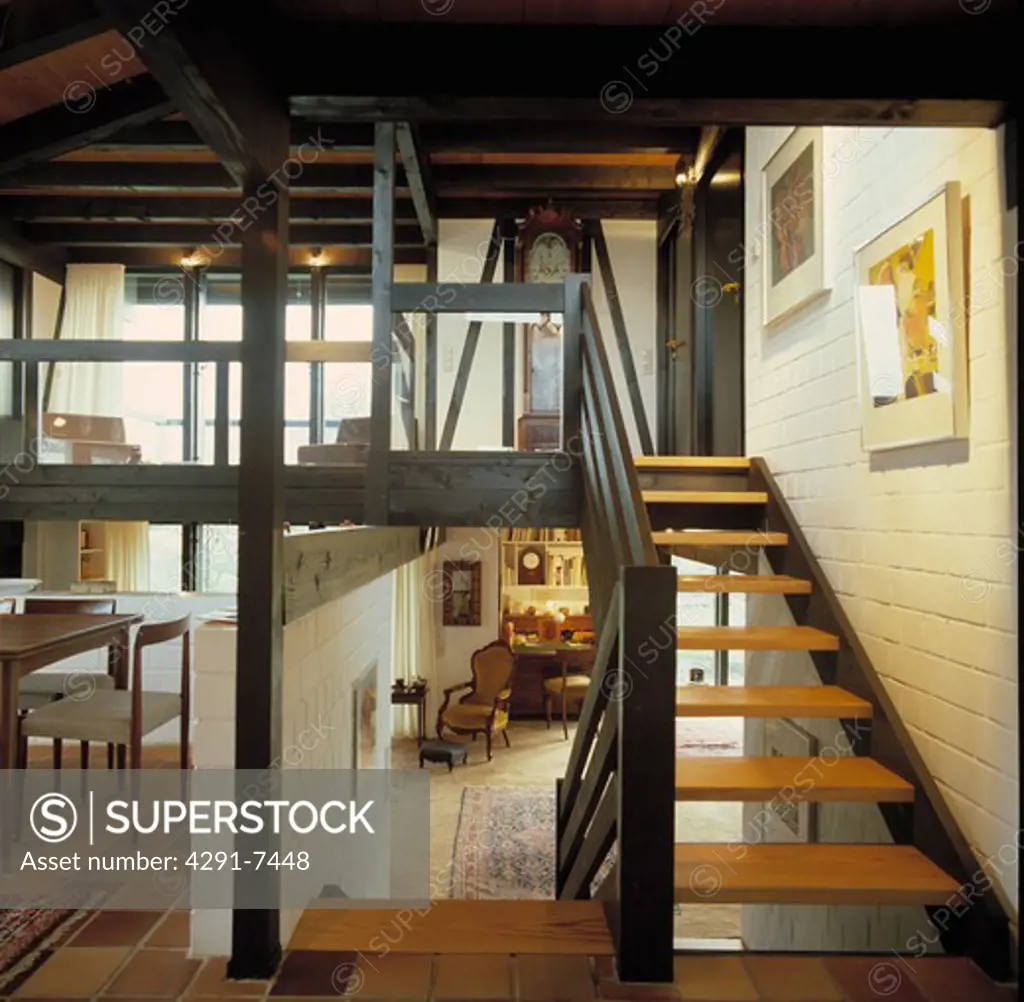 Open-tread wooden staircase in open-plan hall in German country house
