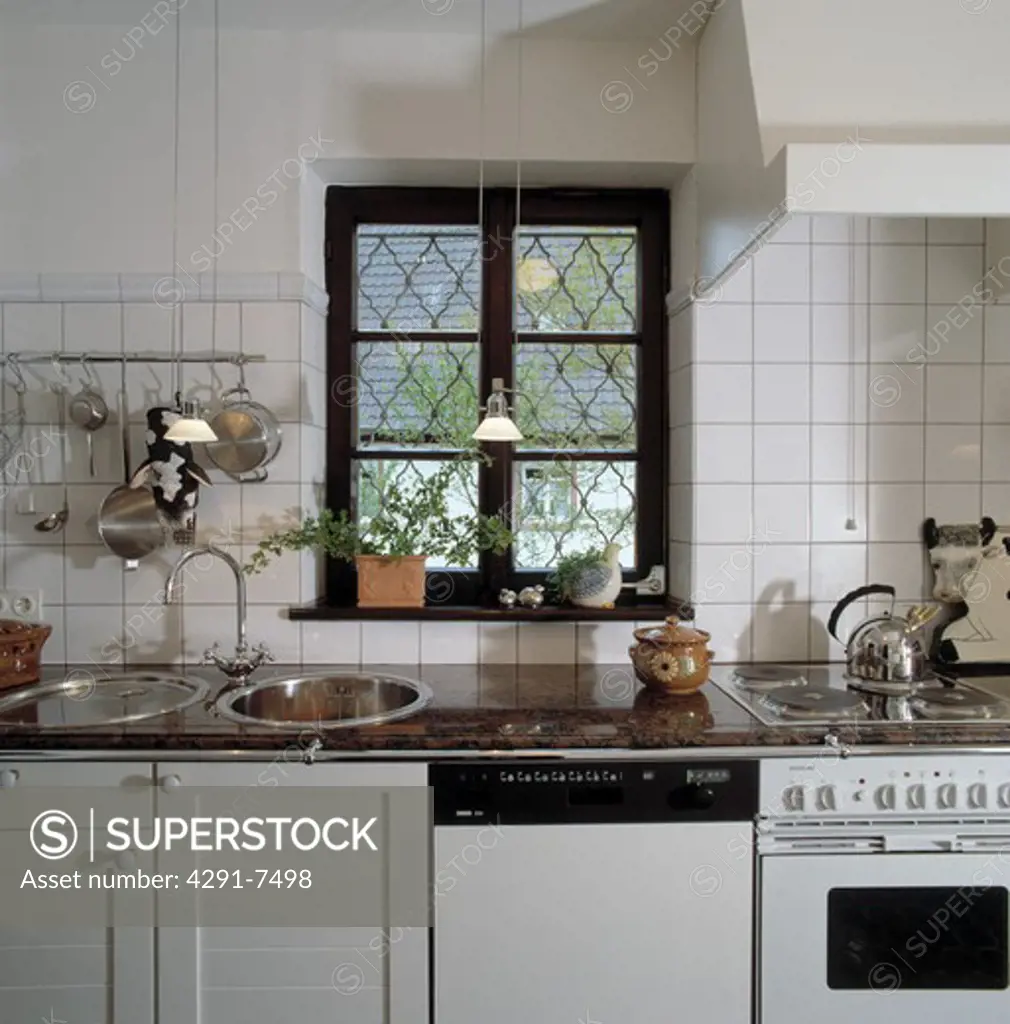 Black and white kitchen with security grill on wndow