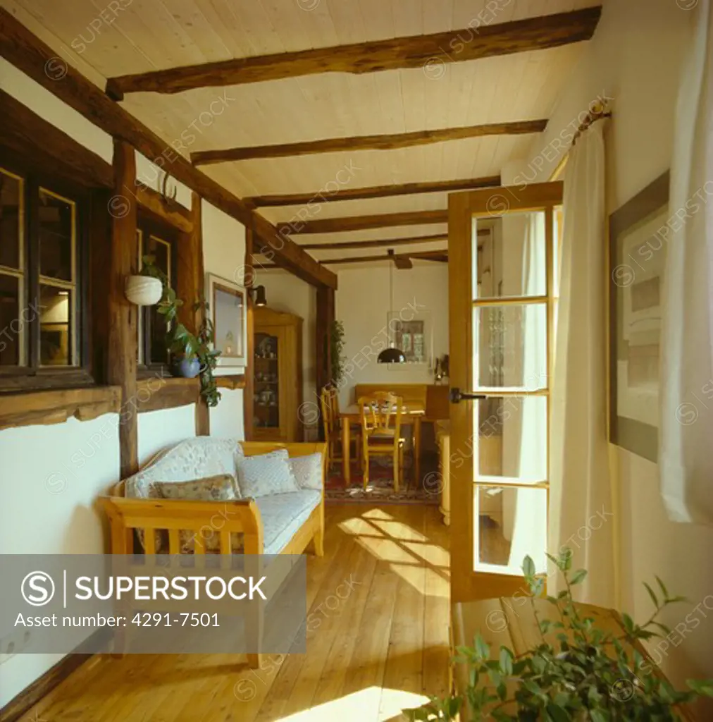 Wooden settle in hall extension with wooden floor