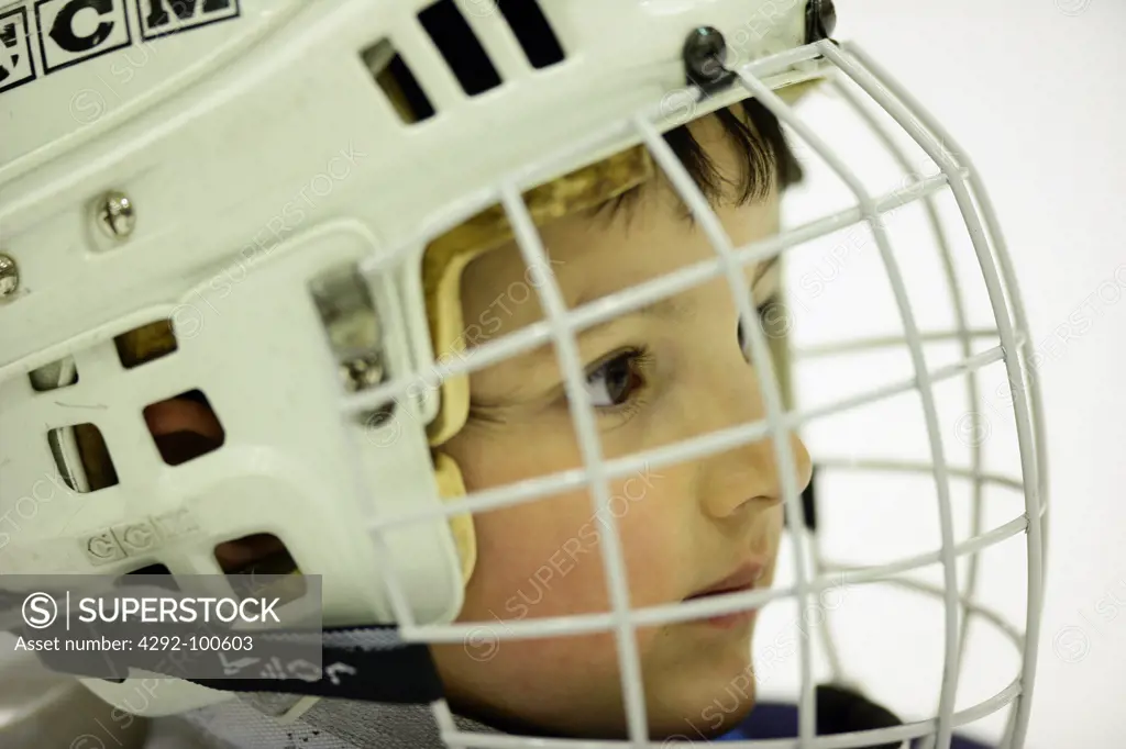 Boy with ice hockey helmet