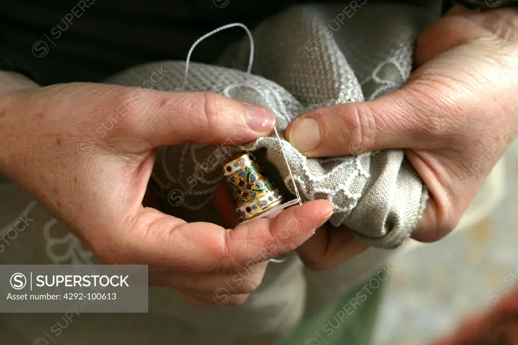 Close up on woman's hands while sewing