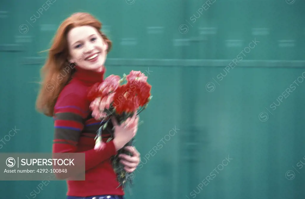 Woman's portrait holding a bouquet of flowers