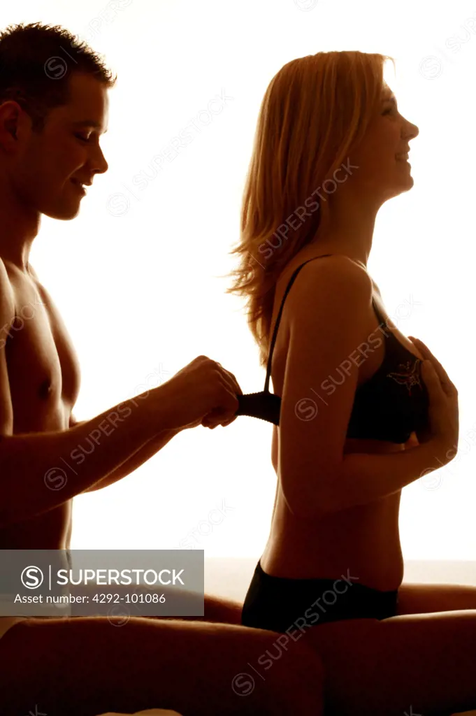 Man undressing woman