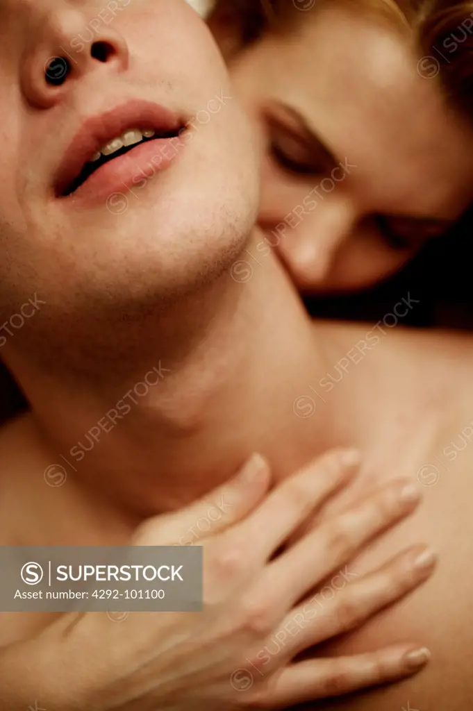 Close-up of man being kissed on the neck