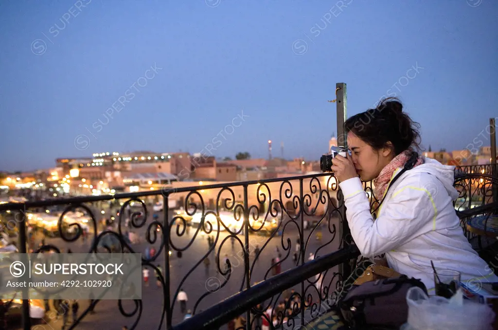 Morocco, Marrakech. Jemaa el Fna square, tourist photographing.
