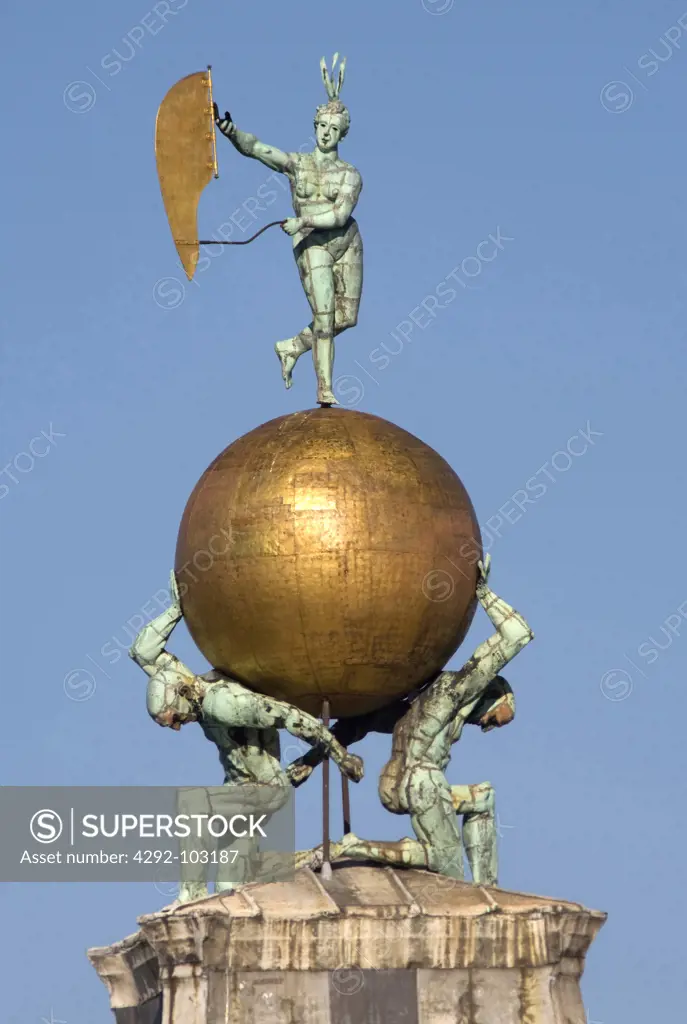 Italy, Venice. Weathervane figure of Fortuna and two bronze Atlases atop the Dogana di Mare or sea customs post in the Dorsoduro district