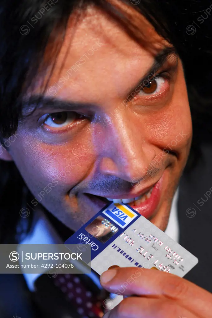 Man biting a credit card
