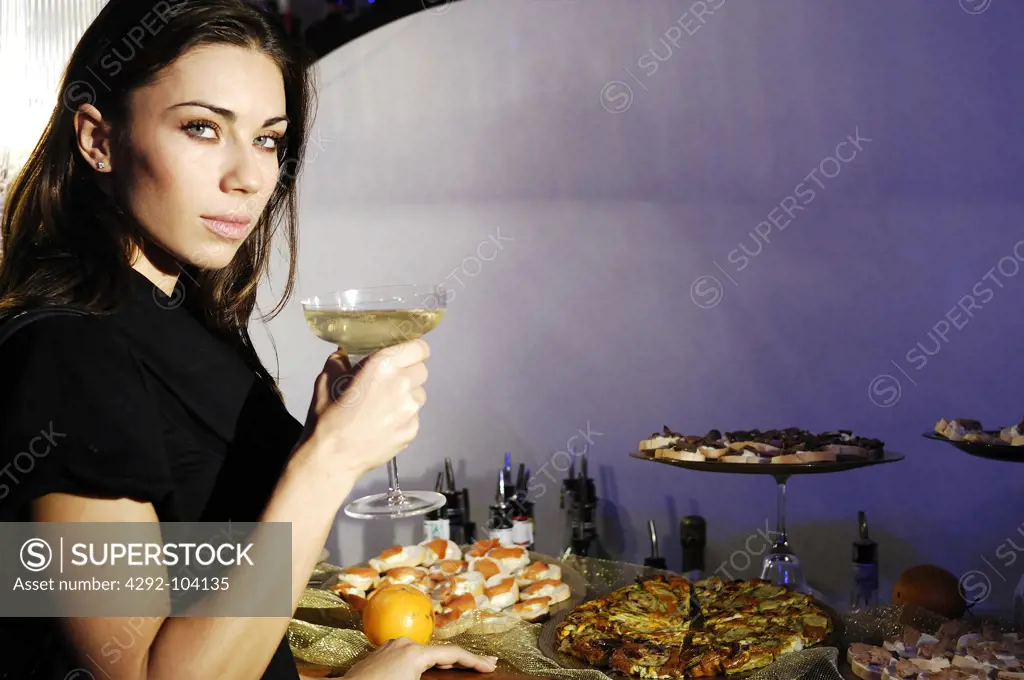 Woman in a bar with a glass champagne